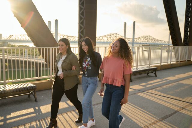 Group of friends walking across bridge