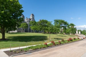 Syracuse campus building with grass and trees