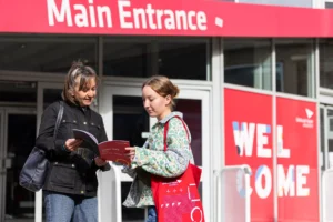 Prospective students exploring opportunities at Edinburgh Napier University Open Day outside the main entrance
