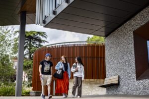 Three students walking together on campus