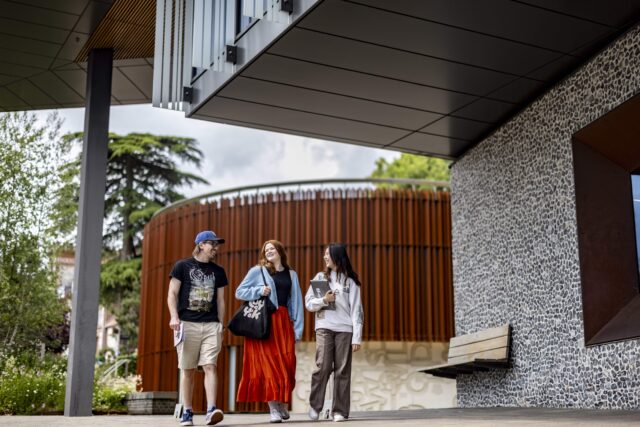Three students walking together on campus