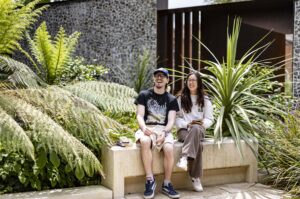University of Winchester two students sat on bench surrounded by plants