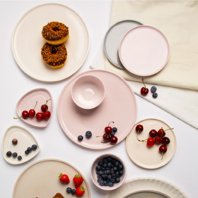 top down view of some plates with fruit and doughnuts on