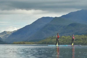 Students paddleboarding on a lake near Bangor University in North Wales