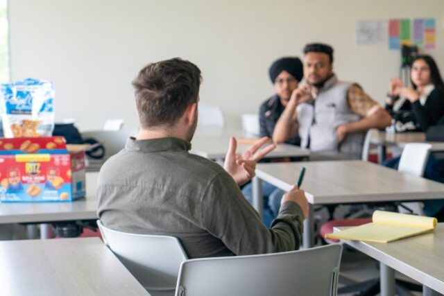 Teacher speaking to students in classroom