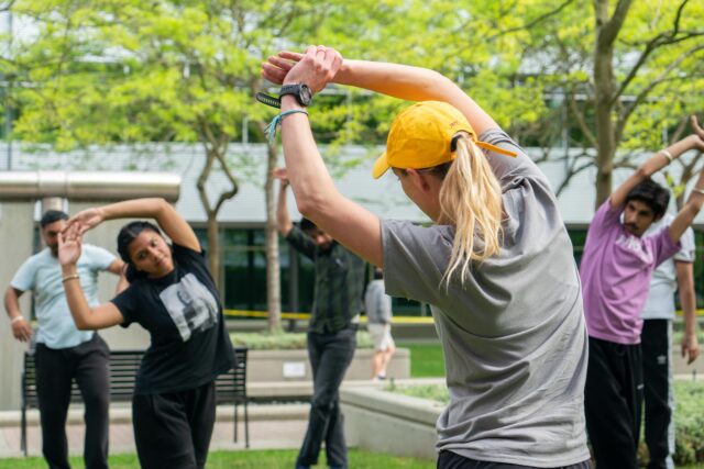 Group of students stretching outside