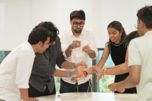Team building exercise with students building a spaghetti tower