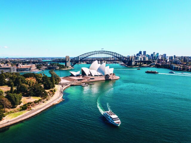 Landscape aerial view of Sydney Opera house near Sydney business center around the harbour.