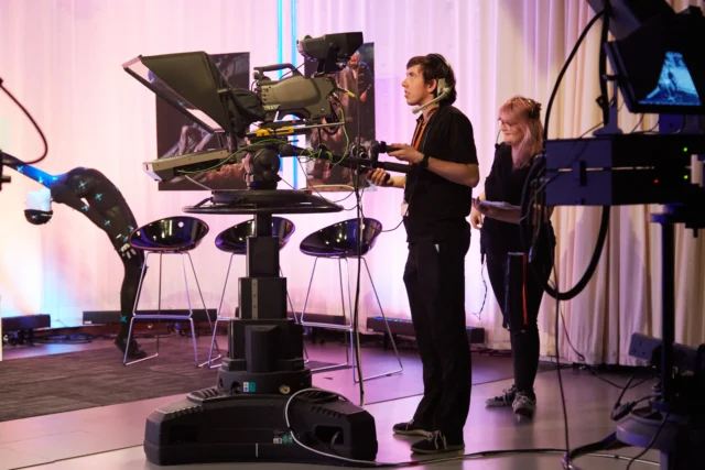 Student using film equipment in TV Studio